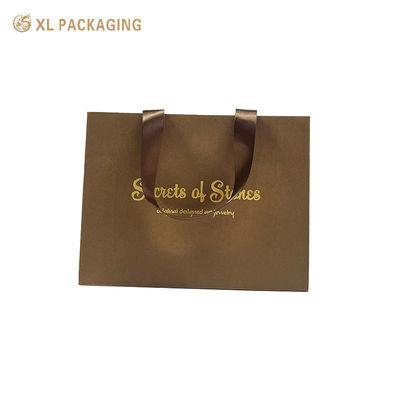 Borsa regalo in carta di lusso con foglio d'oro stampato a caldo, maniglie larghe di nastro di raso e fondo pieghevole triangolare